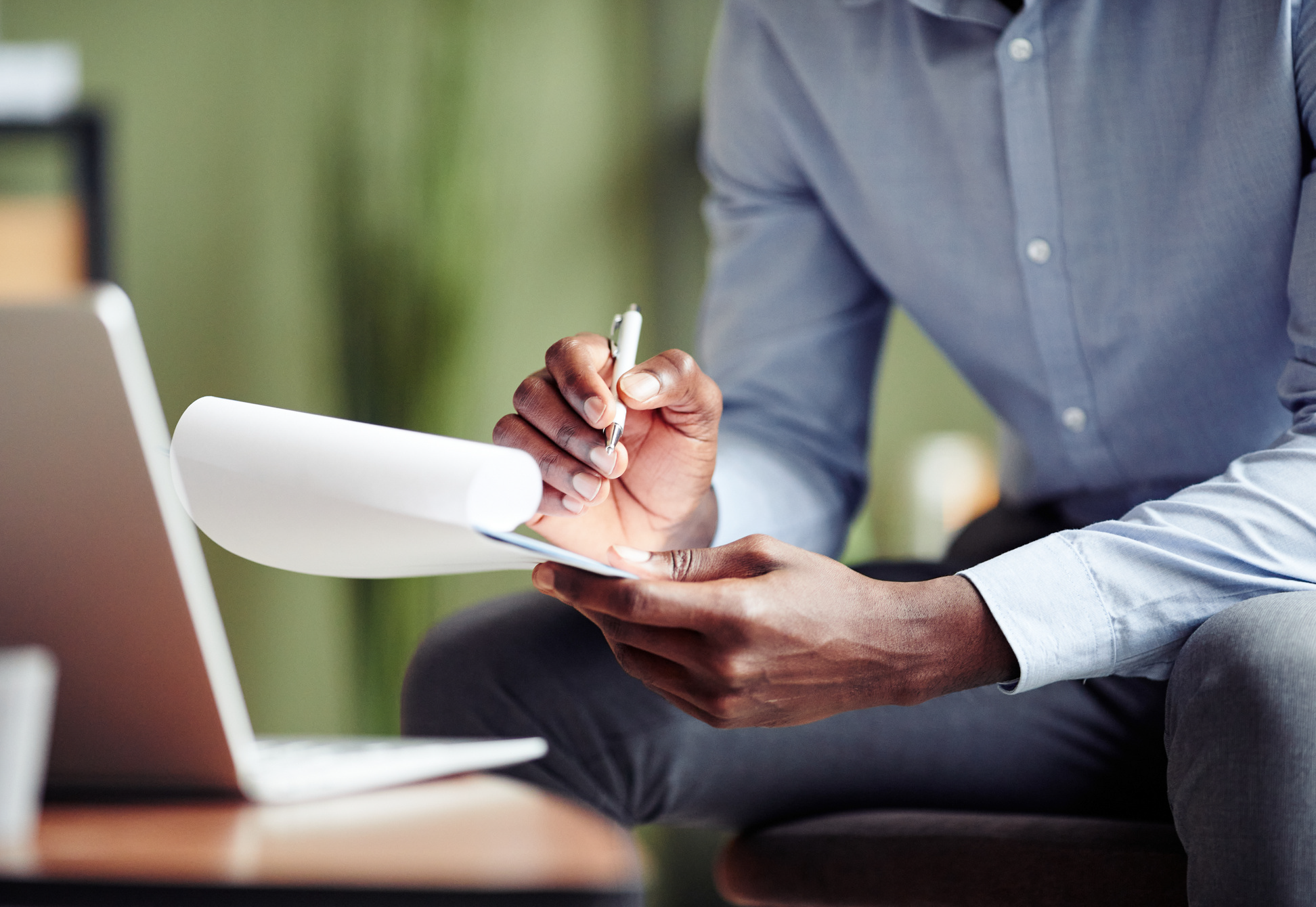 man-writing-on-a-notepad